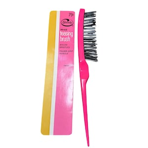 May include: A pink Goody Hi-Lo teasing brush with black nylon bristles and a thumb-grip handle. The packaging is pink and yellow with the text "teasing brush". The brush is designed for styling and backcombing hair.