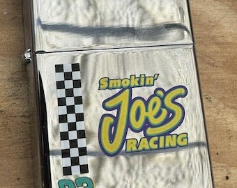 This 1997 Smoking Joe's Racing Zippo lighter is a must-have for any Zippo collector or racing fan.