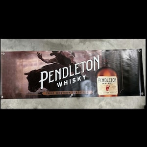 May include: A banner featuring the Pendleton Whisky logo, a cowboy riding a bull, and a bottle of whisky. The banner has a brown and black color scheme with the text "True Western Tradition".