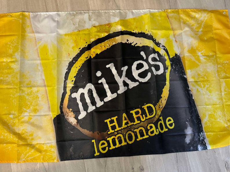 May include: A yellow and black flag with the text "Mike's Hard Lemonade" in a black circle.