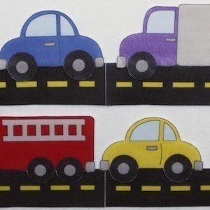 May include: Four toy vehicles on a black road with yellow lines. A blue car, a purple truck, a red fire engine, and a yellow car.