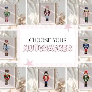 May include: A collection of framed art prints featuring various colorful nutcracker designs. The prints are displayed on a light pink background. The central image reads "CHOOSE YOUR NUTCRACKER".