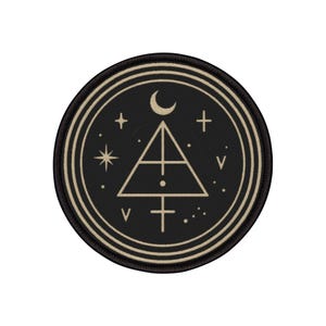 May include: Round black patch with a cream-colored geometric design. The design includes a triangle, a crescent moon, stars, crosses, and other symbols. The patch has a cream-colored border.