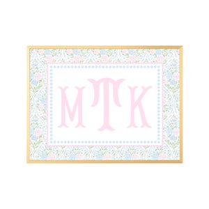 May include: A rectangular wall art print in a thin gold frame featuring a central white rectangle with the pink monogram letters MTK. The border is a light blue dotted line, surrounded by a repeating floral pattern of pink and blue flowers.