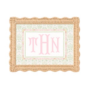 May include: A rectangular picture frame with a scalloped light brown woven wicker border. The inner print features a light green and white floral damask pattern surrounding a white center panel with the large pink monogram letters THN.