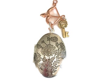 Elongated Oval Floral Decorated Silver-tone Locket with Archery and Key Charms