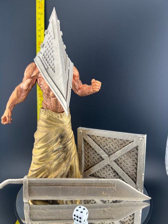 A $2,200 electroformed copper/brass/nickel Pyramid Head sculpture — someone painstakingly plated a 3D-printed Silent Hill icon in real metal layers, and it shows.