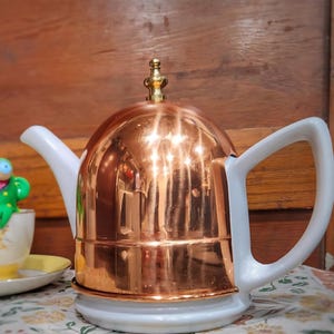 Stuart Hart Ceramic teapot with insulated copper cozy cover and brass knob