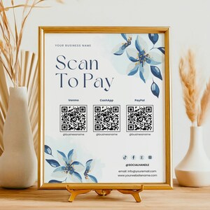 以下が含まれることがあります： 金色の枠と花柄のデザインが施された白い看板。看板には「Scan To Pay」と表示され、Venmo、CashApp、PayPalのQRコードが掲載されています。看板にはソーシャルメディアのハンドルと連絡先情報も記載されています。