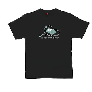 May include: Black t-shirt with a white graphic of an iPod with headphones and the text "it was never a phase".
