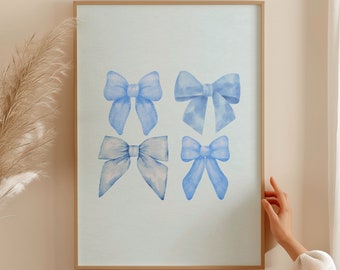 May include: A framed print with a light blue background featuring five watercolor illustrations of blue bows. The bows are arranged in a grid pattern.