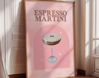 May include: A pink and gold framed poster with the text "Espresso Martini" in a brown font. The poster features a watercolor illustration of an espresso martini in a martini glass with two coffee beans on top.