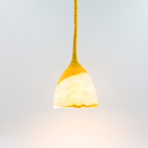 May include: A yellow and white felted pendant light with a long yellow cord.