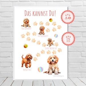May include: A framed print featuring illustrations of playful puppies, paw prints, and colorful balls. The German text "DAS KANNST DU!" is at the top, with phrases like "TOLL GEMACHT!" and "FERTIG? LOS!" below the puppies.