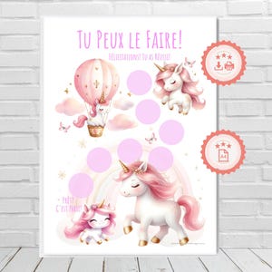 May include: A printable chart with a pink unicorn theme. The chart has a pink hot air balloon with a unicorn in it, a unicorn with a rainbow, and a smaller unicorn. The chart has the text "Tu peux le faire!" and "Félicitations! Tu as réussi!" in French.
