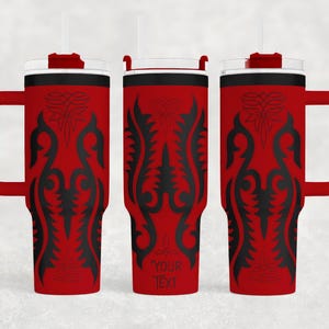 May include: Red insulated tumbler with a black decorative design and a handle. The tumbler has a white straw and a black rim. The text "YOUR TEXT" is printed on the tumbler. This tumbler is perfect for hot or cold beverages.