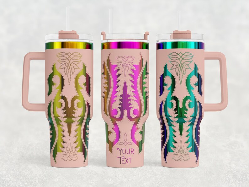 May include: Three insulated tumblers with handles and straws. Each tumbler is light pink with a colorful, ornate design. The designs feature a central vertical pattern with a floral motif. The tumblers have a handle and a lid with a straw.