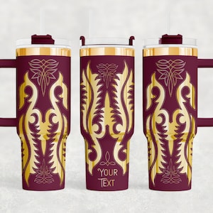 May include: A set of three maroon insulated tumblers with gold filigree designs. Each tumbler has a handle, a clear lid, and a straw. The text "YOUR TEXT" is visible on one of the tumblers. These tumblers are suitable for hot or cold beverages.