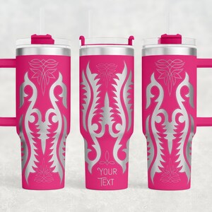 May include: Three pink insulated tumblers with silver ornamental designs and handles. Each tumbler has a clear lid, a straw, and the text "YOUR TEXT" on one. The tumblers are designed to keep drinks cold or hot.