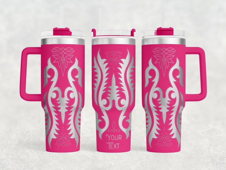 May include: Three pink insulated tumblers with silver ornamental designs and handles. Each tumbler has a clear lid, a straw, and the text "YOUR TEXT" on one. The tumblers are designed to keep drinks cold or hot.