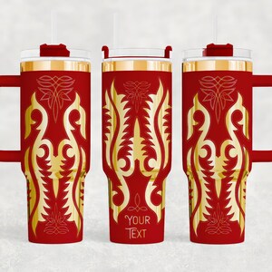 May include: Red insulated tumbler with a gold ornate design and a handle. The tumbler has a clear lid, a red handle, and a gold rim. The design includes the text "YOUR TEXT" in a decorative font. The tumbler is designed to hold cold or hot beverages.