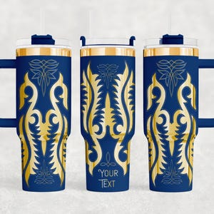 May include: Navy blue insulated tumbler with a gold ornamental design. The tumbler has a handle, a clear lid, and a straw. The design includes the text "YOUR TEXT" at the bottom. The tumbler is designed to hold cold or hot beverages.