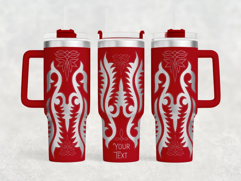 May include: Red insulated tumbler with a silver ornamental design and a handle. The tumbler has a clear lid, a red straw, and the text "YOUR TEXT" at the bottom. The design is symmetrical and features floral and leaf-like patterns.