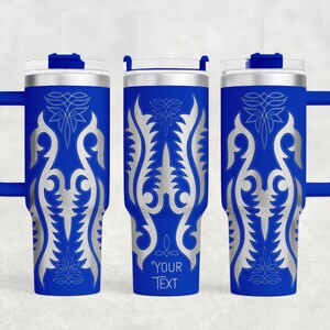 May include: Three blue insulated tumblers with silver ornate designs and handles. Each tumbler has a silver lid, a straw, and the text "YOUR TEXT" on one. The tumblers are designed to keep beverages cold or hot.