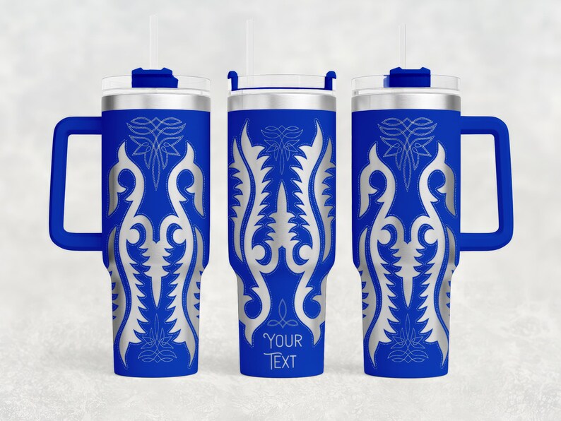 May include: Three blue insulated tumblers with silver ornate designs and handles. Each tumbler has a silver lid, a straw, and the text "YOUR TEXT" on one. The tumblers are designed to keep beverages cold or hot.