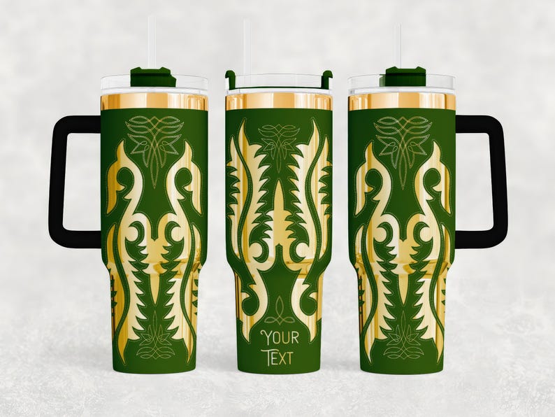 May include: Green travel tumbler with a gold ornamental design and a black handle. The tumbler has a clear lid and a straw. The text "YOUR TEXT" is printed on the tumbler.