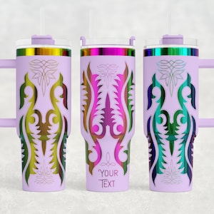 May include: Three lavender insulated tumblers with handles, each featuring a different colorful, symmetrical design. The designs include gold, green, pink, and blue accents. Each tumbler has a lid and a straw. One tumbler has the text "YOUR TEXT".