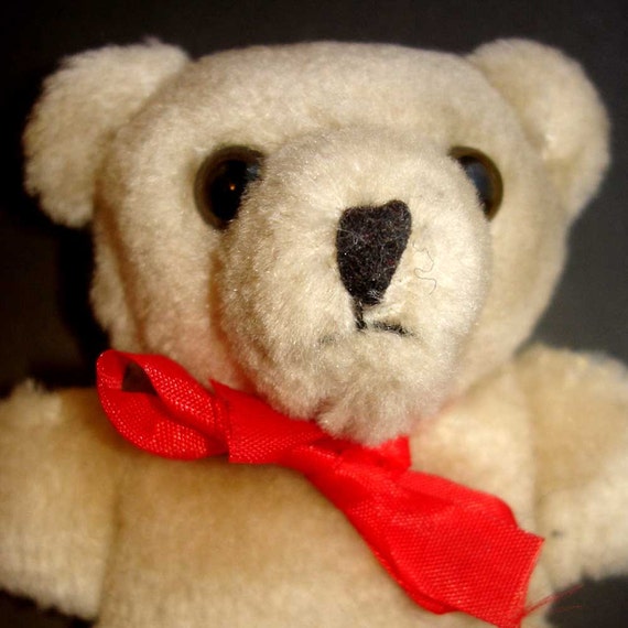 brown teddy bear with red bow tie