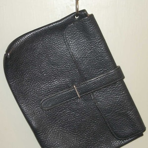May include: A black leather satchel bag with a silver buckle and a silver hook closure.