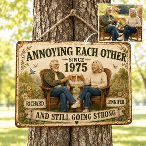 May include: A rectangular metal sign featuring a couple sitting in wooden chairs, holding beer mugs. The text reads: ANNOYING EACH OTHER SINCE 1975, RICHARD, JENNIFER, AND STILL GOING STRONG. The background shows a garden with flowers and birds.
