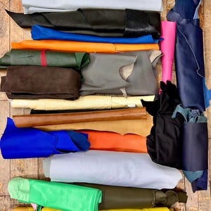 Assorted Scrap Leather Pieces for Crafting - Mixed Colors and Textures Perfect for crafting or small leather goods.  Half to Full Skins.