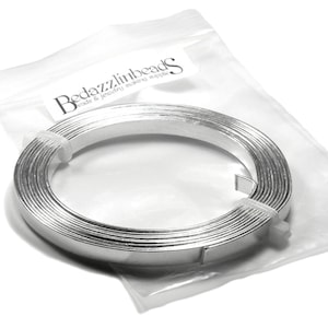 May include: A roll of silver aluminium wire in a clear plastic bag. The bag has the text "Bedazzlinbeads Craft & Jewelry Making Supplies" printed on it.
