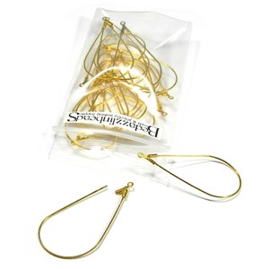 May include: A bag of gold teardrop shaped earring wires. The bag has a label that says "BeadzzinBeads, cords & jewellery findings".