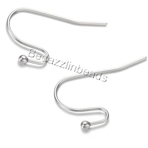 May include: Two silver-colored earring hooks with a curved design. Each hook has a small, round bead at the bottom and the text "Bedazzlinbeads" is visible in the image.
