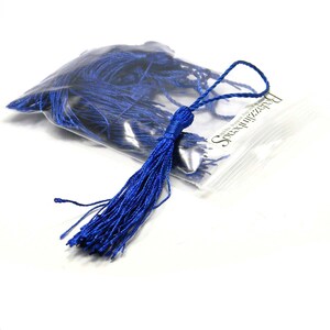 May include: A bag of royal blue tassel trim, with one tassel pulled out of the bag. The bag has a label that says "Special Occasions".