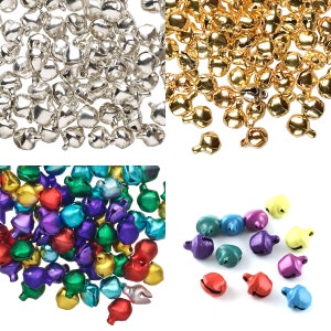 May include: Assortment of small jingle bells in various colors, including silver, gold, purple, green, and blue. The bells are arranged in groups on a white background.