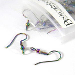 May include: A close-up of rainbow-colored earring hooks with a spring-loaded closure. The hooks are made of metal and have a shiny finish. The hooks are packaged in a clear plastic bag with the text "Beads & Jewelry Supplies" printed on the bag.