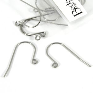 May include: Silver earring hooks, a close-up of three earring hooks, two are straight and one is a french hook.