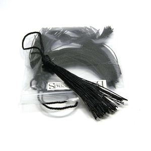 May include: A bag of black tassel cords, with one tassel hanging out of the bag. The bag has the text "Simply Beads" printed on it.