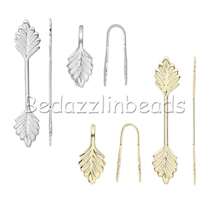 May include: Two sets of leaf-shaped jewelry findings, one in silver and one in gold. Each set includes a pendant, a loop, and a straight piece with a leaf on each end.