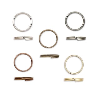 May include: Assortment of key rings in various metallic finishes, including silver, bronze, and gold. The key rings are shown in both top-down and side views, highlighting their split ring design for easy attachment of keys or charms.