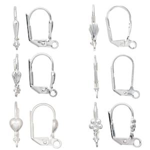 May include: Silver-toned earring findings in various styles, including lever-back and decorative designs. The image showcases several pairs of earring components, with different shapes and embellishments, ready for jewelry making.