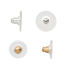 May include: Four clear plastic earring backs with a silver post and a gold post. The backs are round and have a small hole in the center.