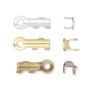 May include: Close-up of jewelry findings in silver, gold, and bronze tones. The findings include key-shaped clasps and matching end pieces, ideal for jewelry making. The pieces are arranged on a white background.