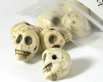 May include: A bag of white skull beads with brown detailing. The beads are made of bone or a bone-like material.