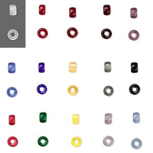 May include: A collection of colorful glass beads in various shapes, including round, cylindrical, and donut-shaped. The beads are in shades of red, blue, green, yellow, and black, with some translucent and others opaque.
